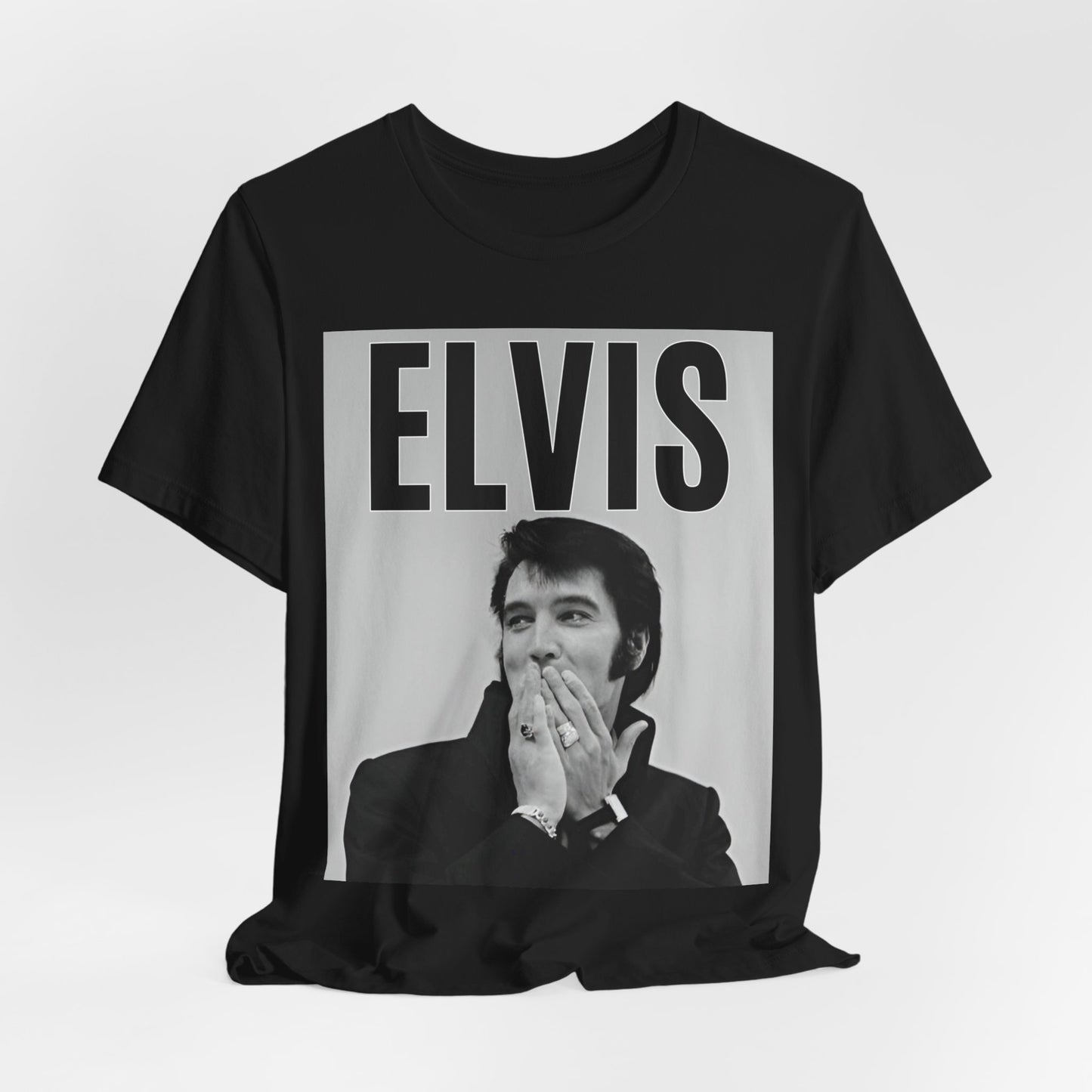 A black graphic t-shirt featuring a retro graphic of Elvis Presley as a 'Rebel With A Cause.'