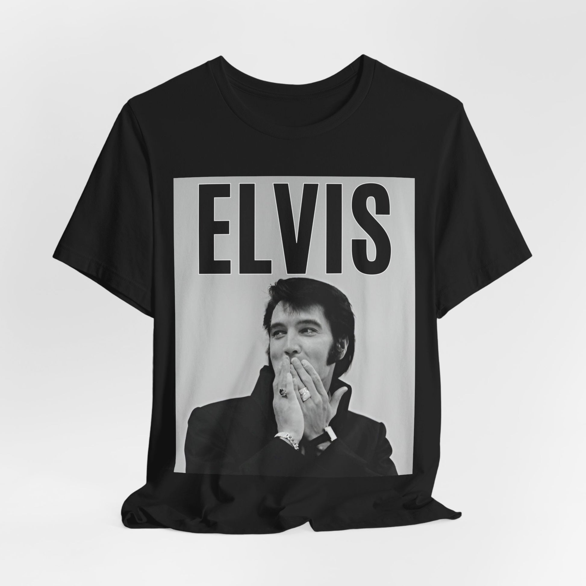 A black graphic t-shirt featuring a retro graphic of Elvis Presley as a 'Rebel With A Cause.'