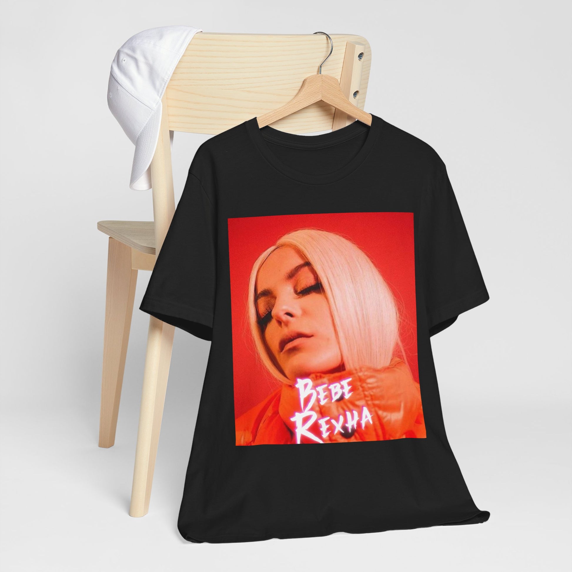 A black graphic t-shirt featuring a graphic of Bebe Rexha, designed with a glamorous or dazzling aesthetic.