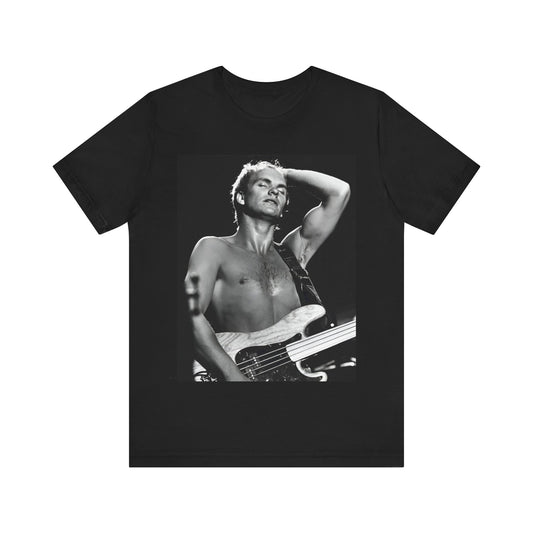 A black graphic t-shirt featuring a graphic or photo of Sting performing live on stage in 1983.