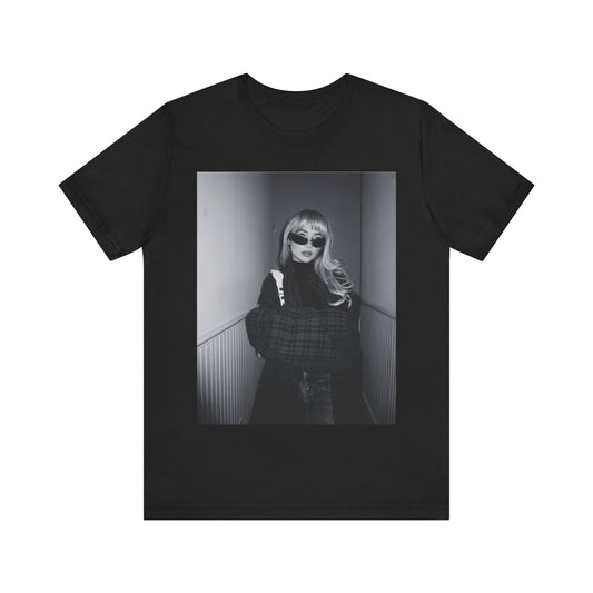 A black graphic t-shirt featuring a black and white glam pop diva graphic of Sabrina Carpenter.