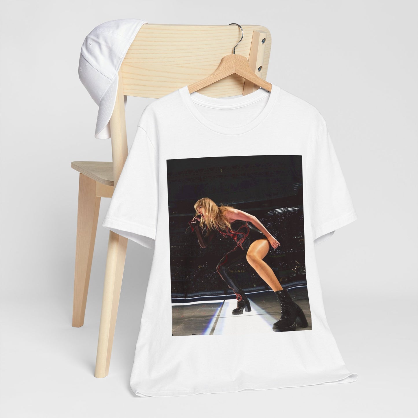 A black graphic t-shirt featuring a fierce graphic of Taylor Swift on stage.