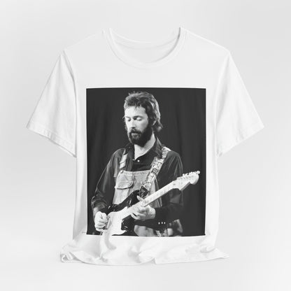 A black graphic t-shirt featuring a graphic or photo of Eric Clapton performing live on stage with his guitar.