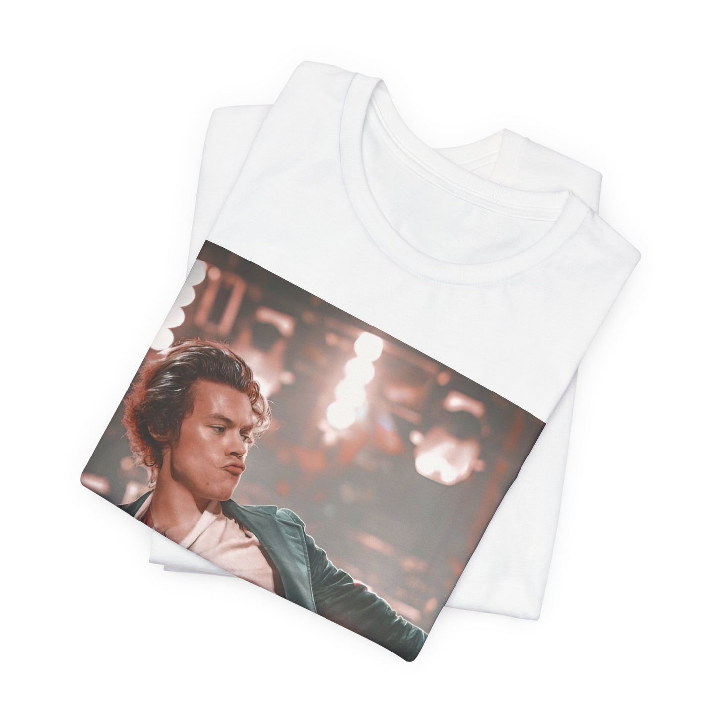 A black graphic t-shirt featuring a graphic or photo of Harry Styles performing live on concert tour.