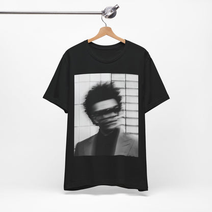 A black graphic t-shirt featuring a blurred graphic of The Weeknd from his 'After Hours' era.