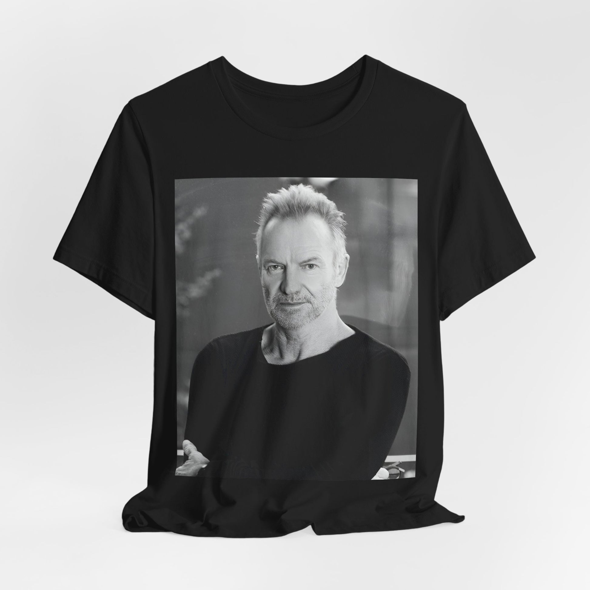 A black graphic t-shirt featuring a vintage graphic related to Sting's 'Desert Rose' song or era.
