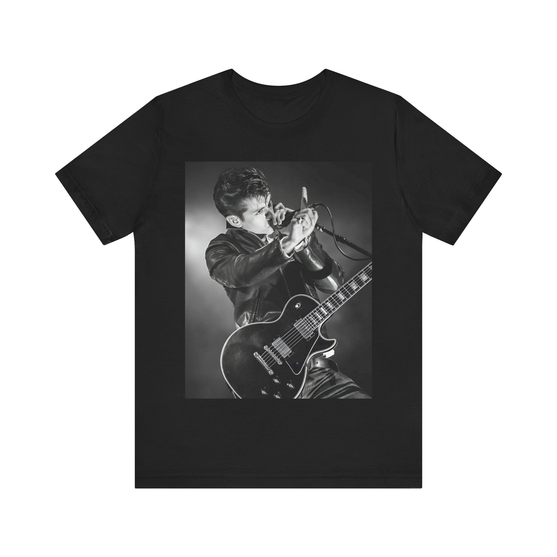 A black graphic t-shirt featuring a dynamic black and white graphic or photo of Arctic Monkeys performing live, emphasizing energy.