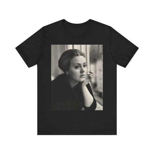 A black graphic t-shirt featuring a black and white photo of Adele, showing her with a serene or thoughtful expression.