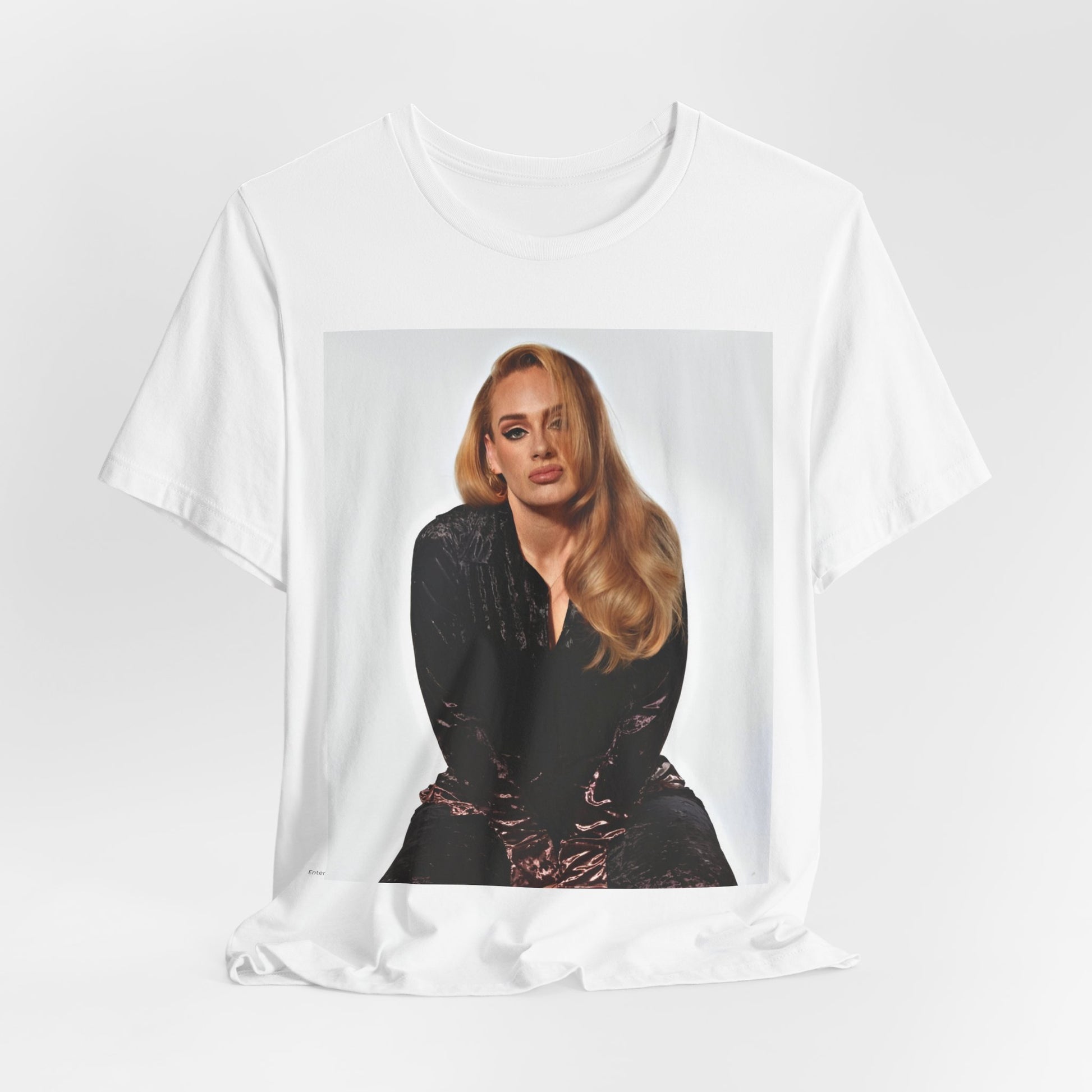 A black graphic t-shirt featuring a portrait of Adele from her iconic blonde era, with her hair styled and her expression poised and elegant.