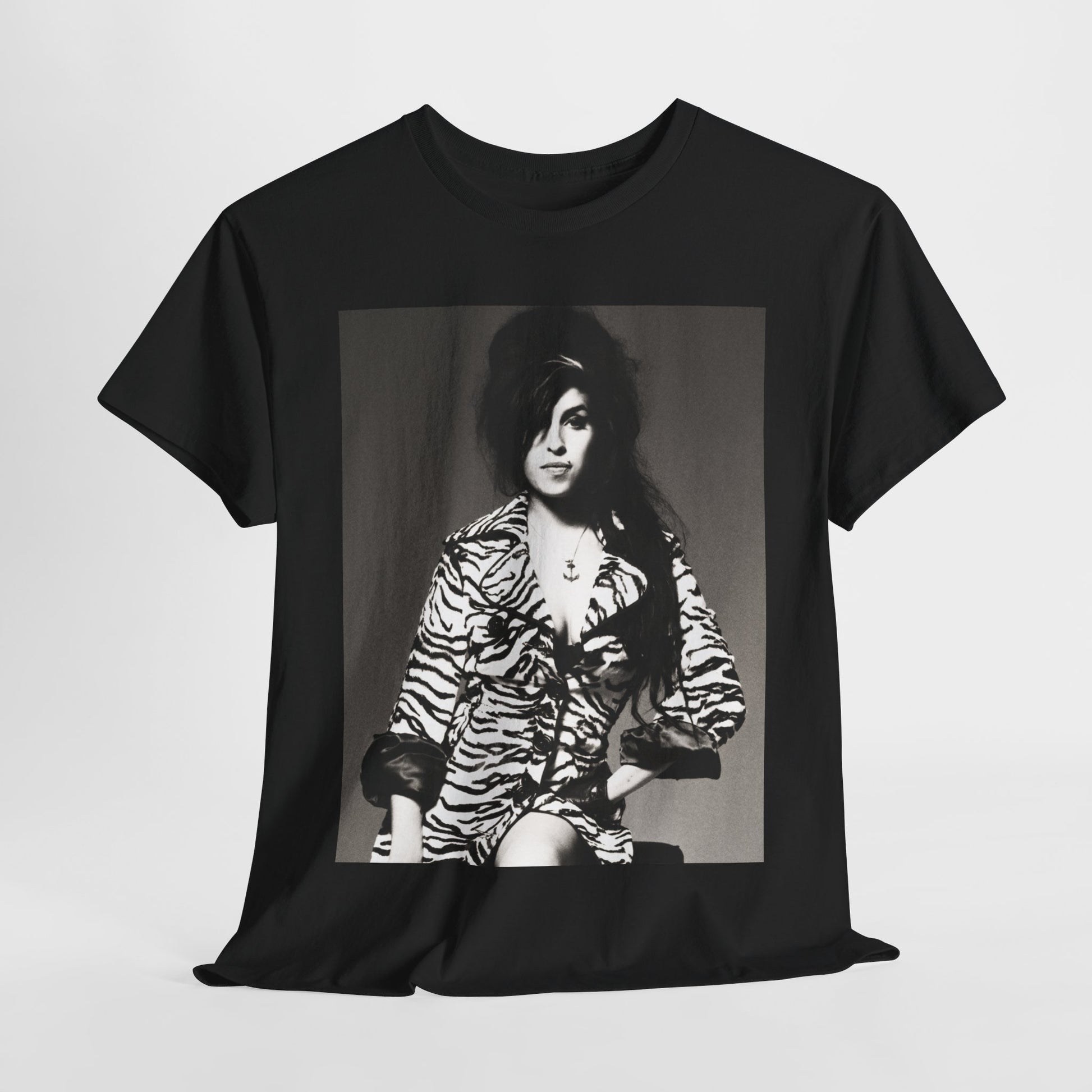 A black graphic t-shirt featuring a vintage black and white portrait of Amy Winehouse, showing her with her signature beehive and soulful expression.