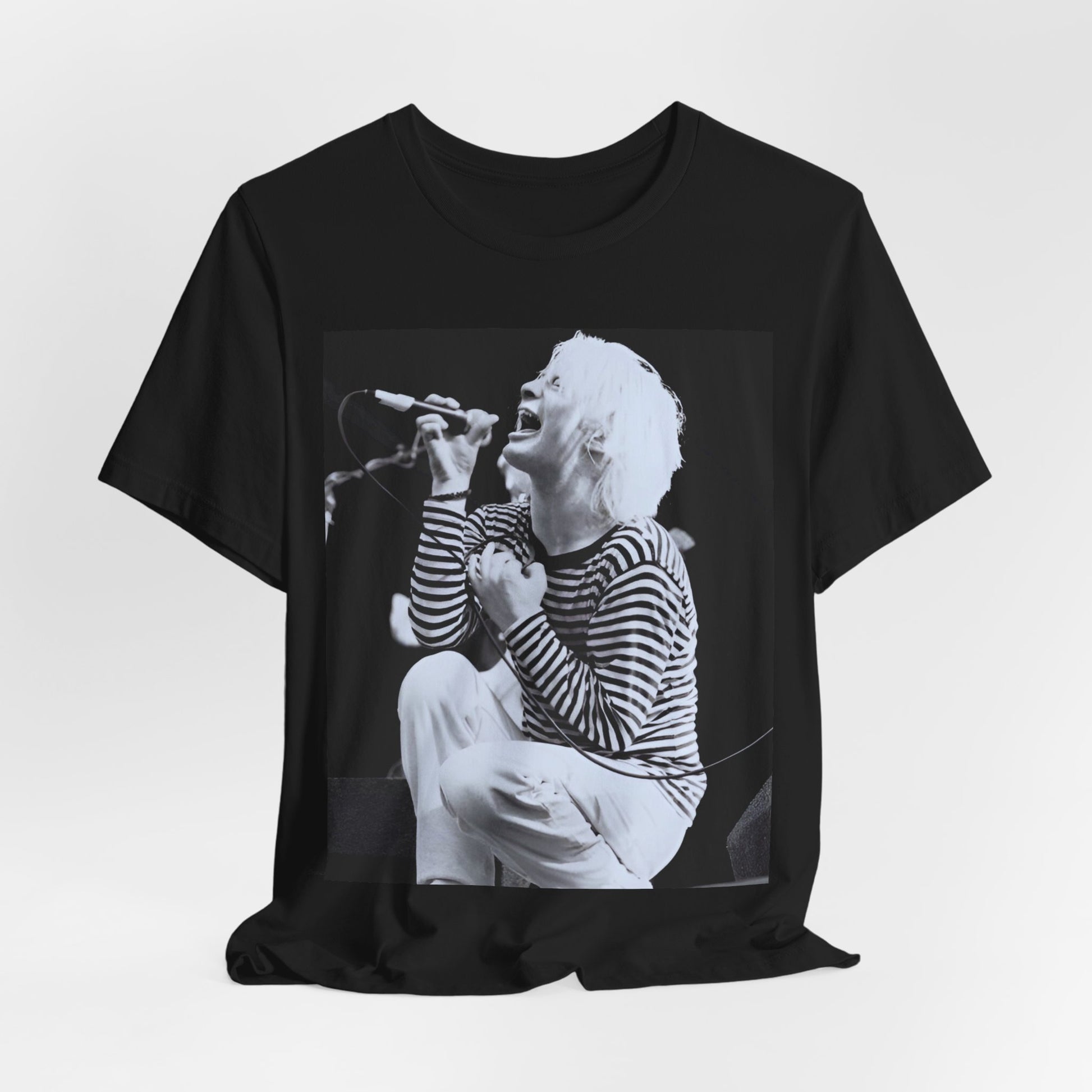 A black graphic t-shirt featuring a black and white graphic or photo of Radiohead performing live.