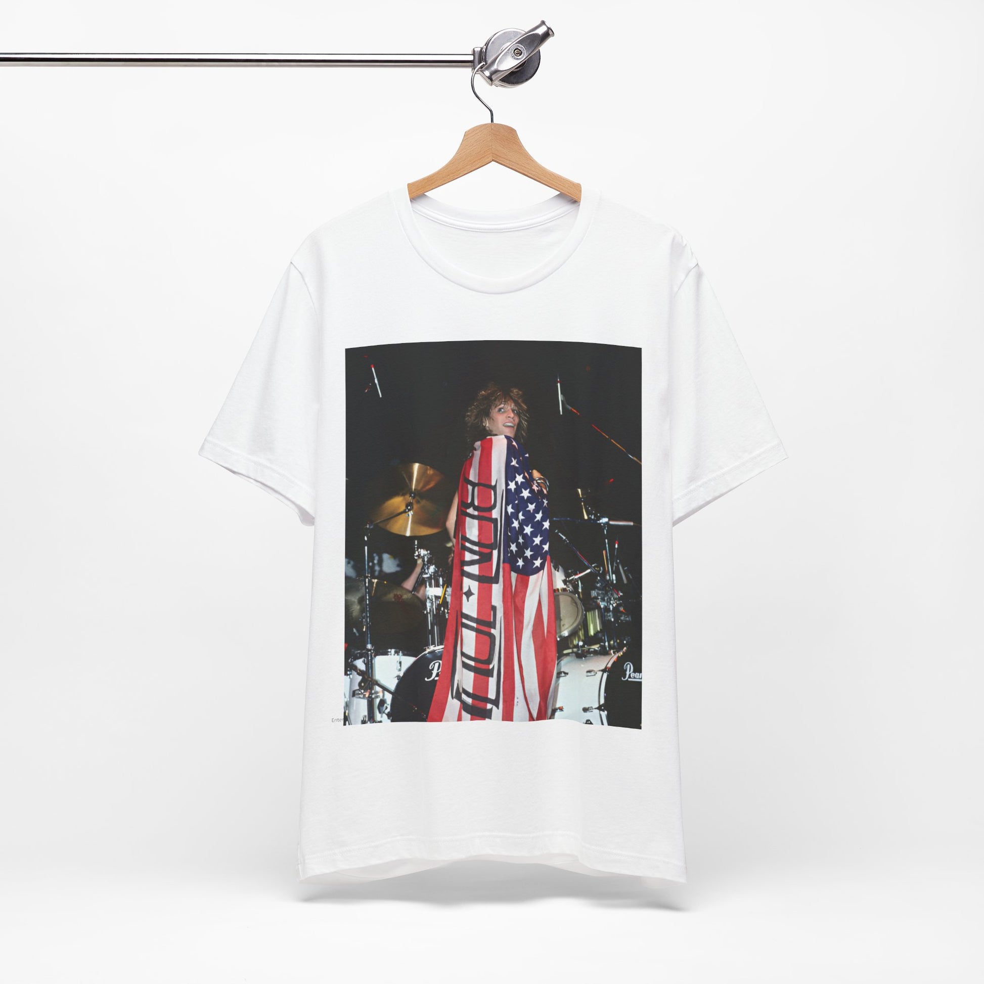 A black graphic t-shirt featuring a graphic of Bon Jovi performing on stage with an American flag as a backdrop.