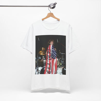 A black graphic t-shirt featuring a graphic of Bon Jovi performing on stage with an American flag as a backdrop.