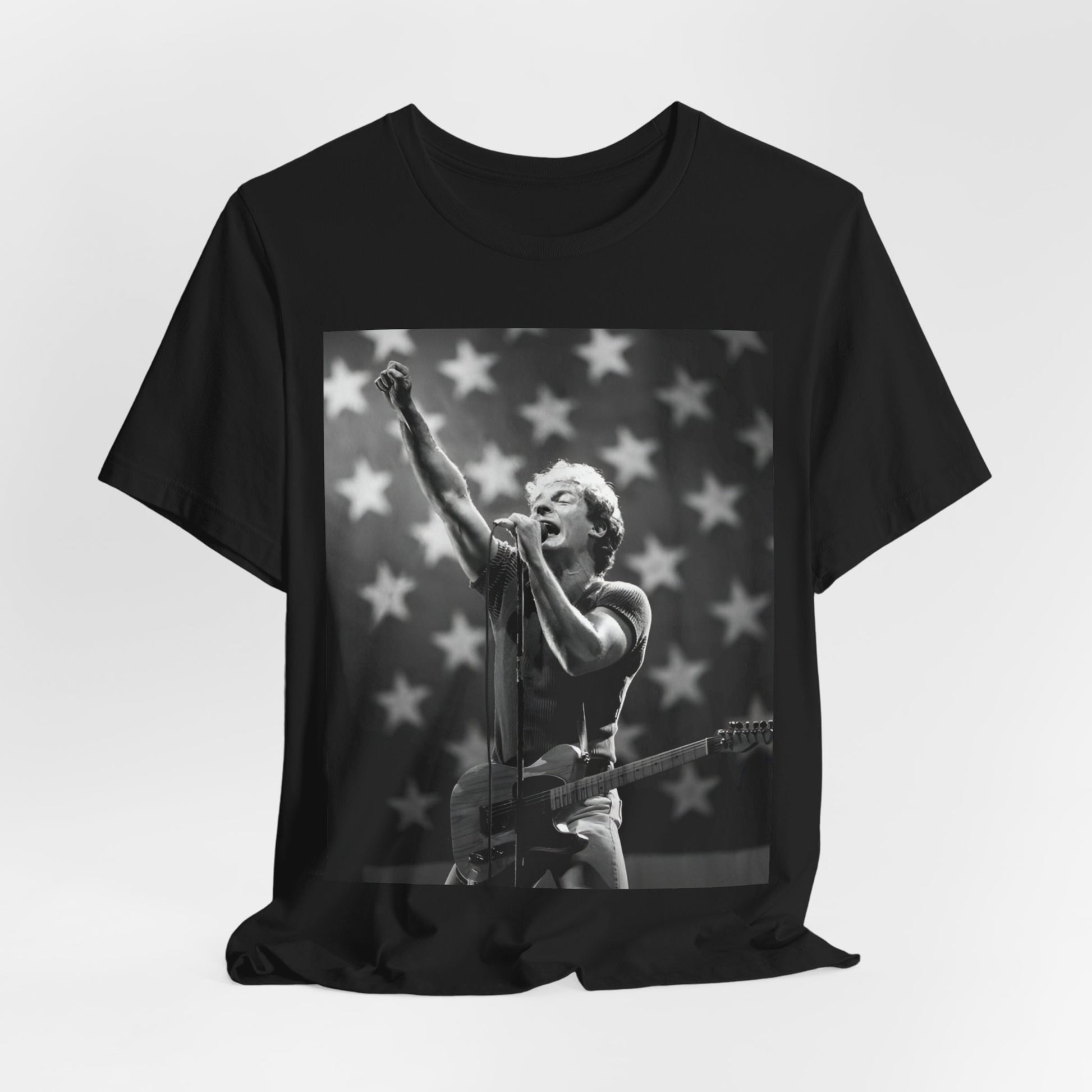 A black graphic t-shirt featuring a 70s era Americana-style graphic of Bruce Springsteen.