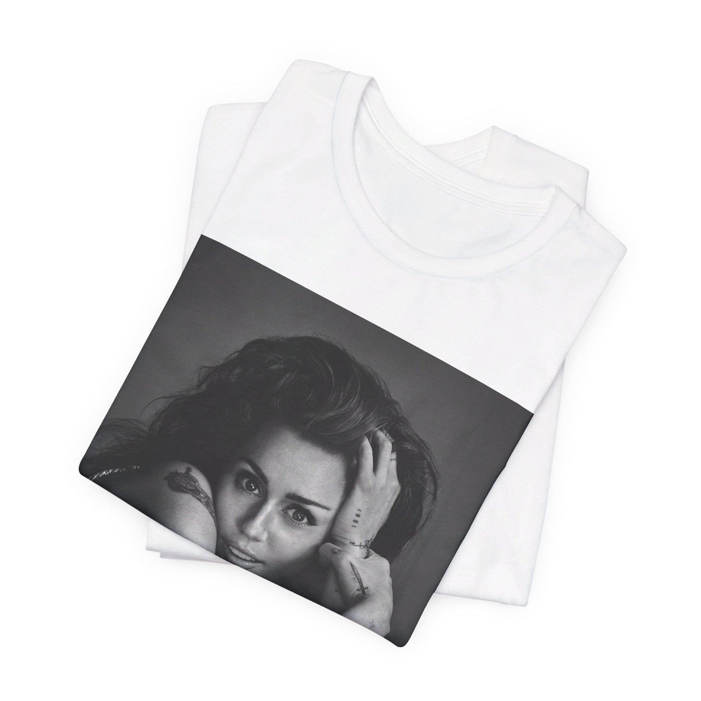 A black graphic t-shirt featuring a black and white portrait graphic of Miley Cyrus.
