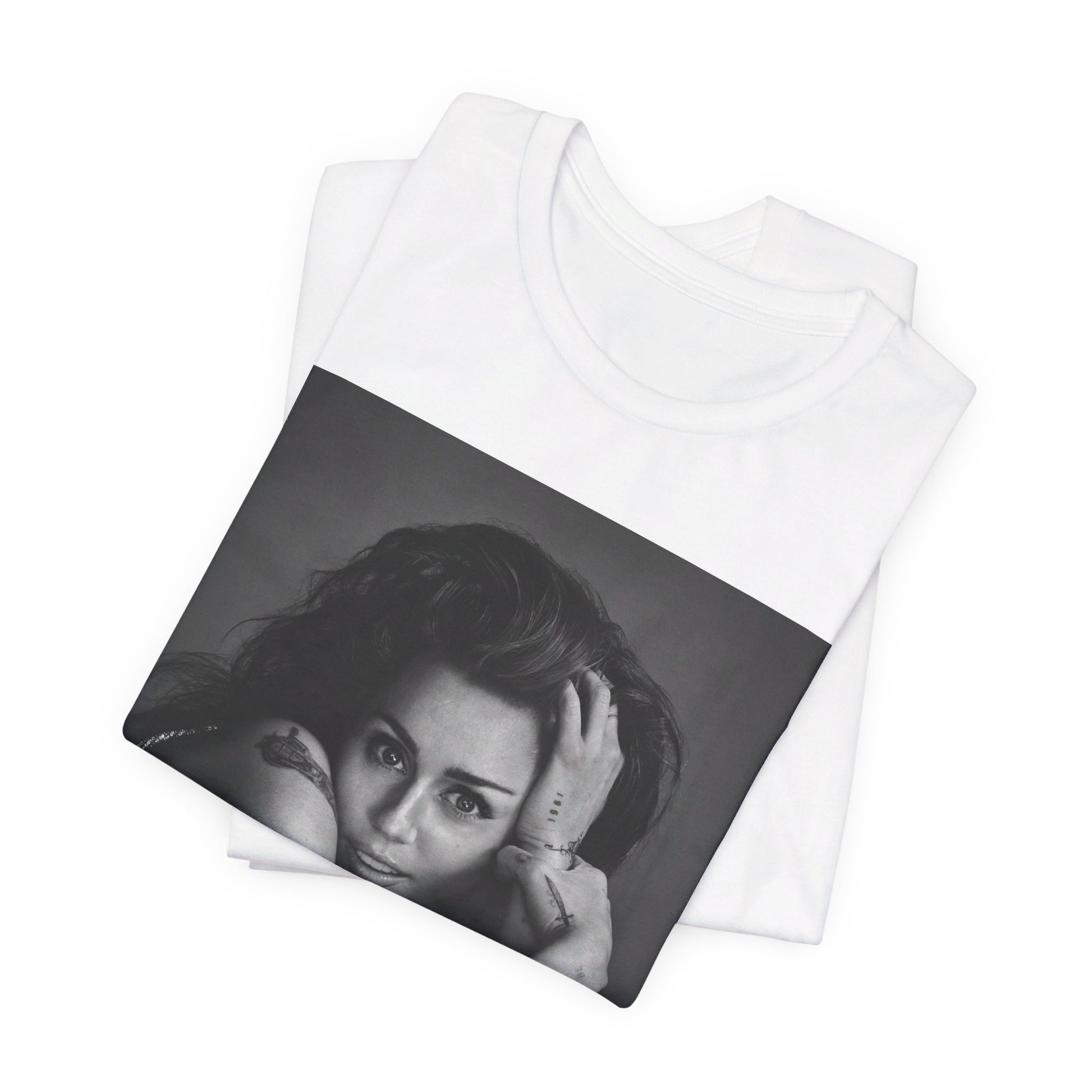 A black graphic t-shirt featuring a black and white portrait graphic of Miley Cyrus.