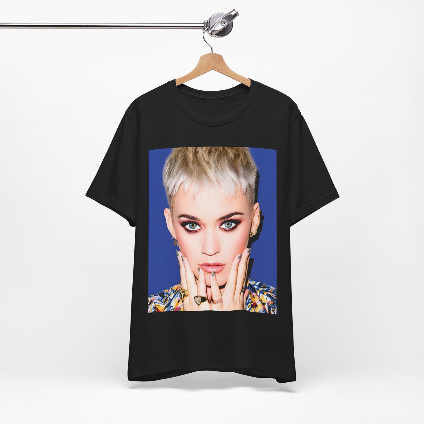 A black graphic t-shirt featuring a graphic of Katy Perry as a global pop phenomenon.