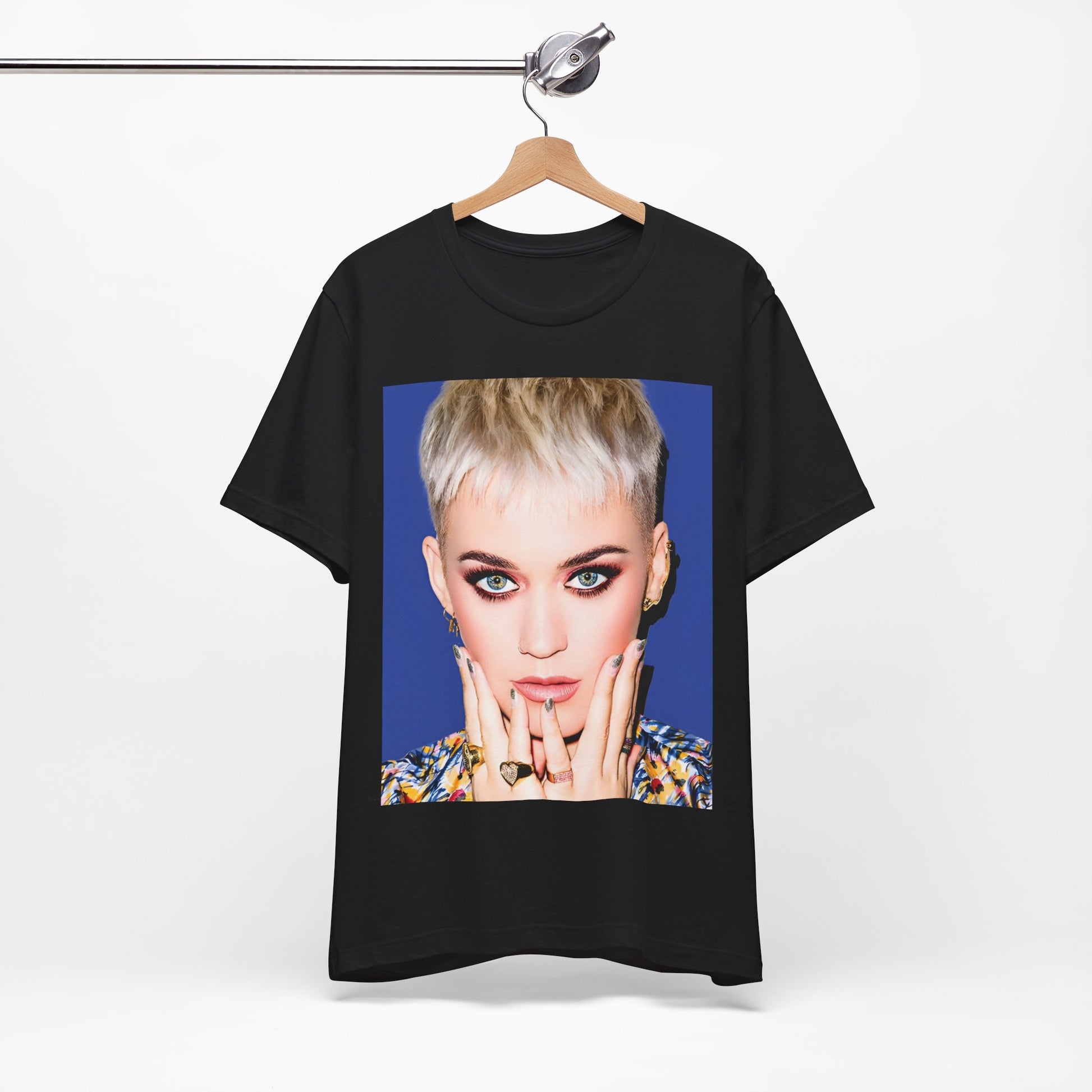 A black graphic t-shirt featuring a graphic of Katy Perry as a global pop phenomenon.