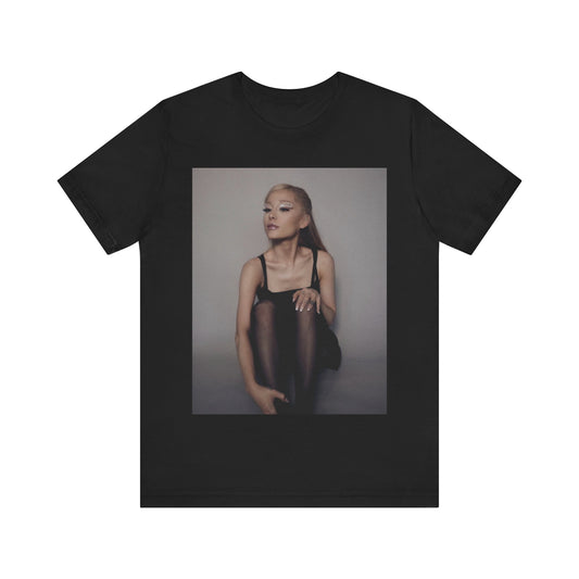 A black graphic t-shirt featuring a bold and beautiful graphic of Ariana Grande, emphasizing her strong and confident presence.