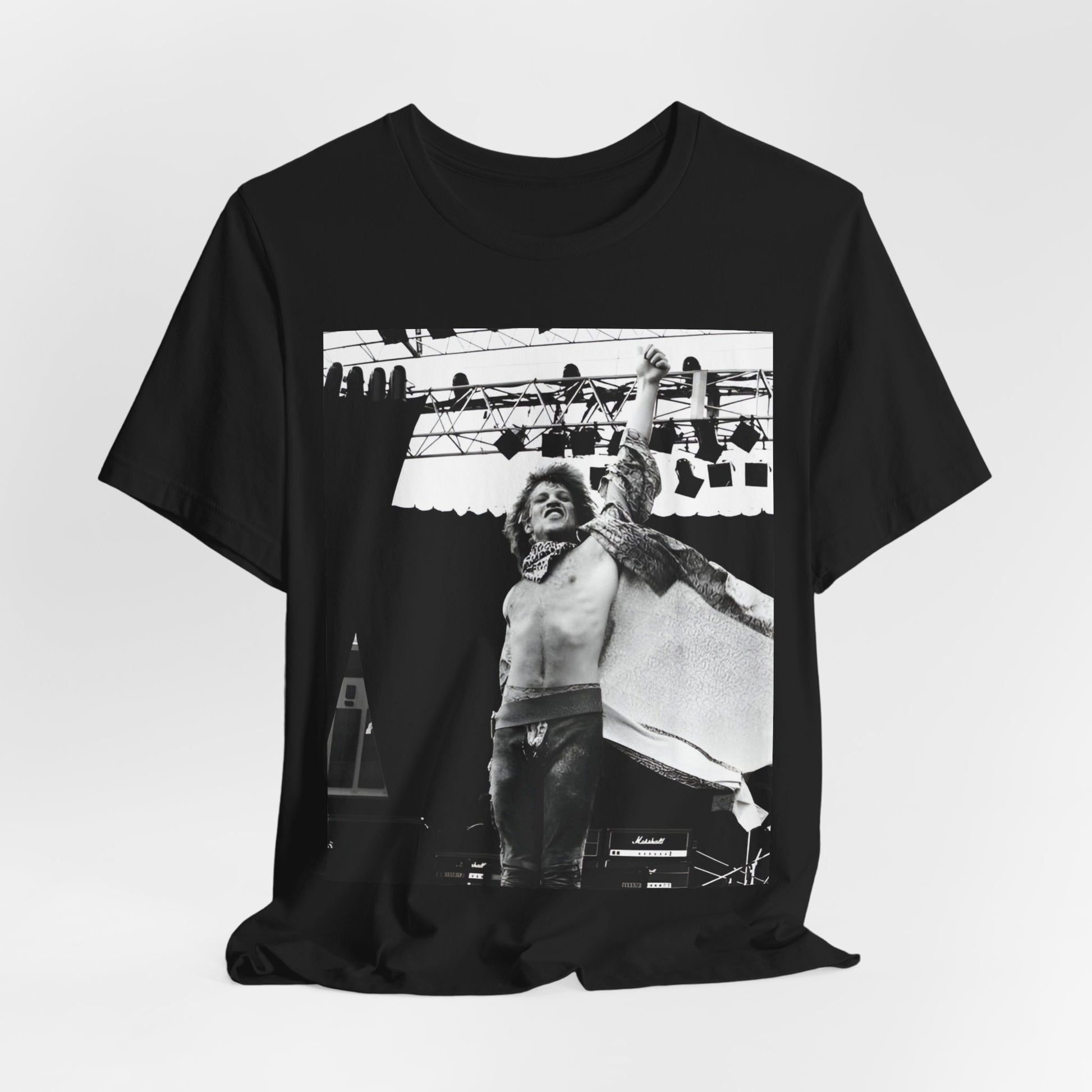 A black graphic t-shirt featuring an epic arena rock graphic of Bon Jovi performing on a large stage.