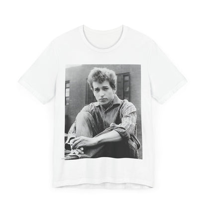 A black graphic t-shirt featuring a graphic of Bob Dylan from his 60s origins in folk music.