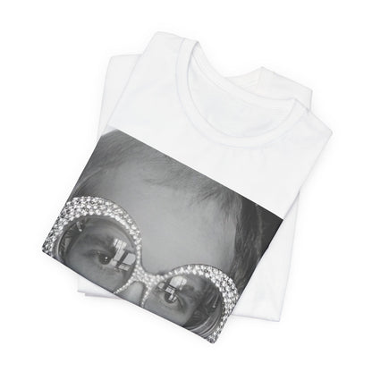 A black graphic t-shirt featuring a graphic of Elton John emphasizing his iconic glasses and fashion.
