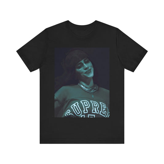 A powerful, close-up portrait of Billie Eilish with a direct and intense stare, printed on a graphic t-shirt.