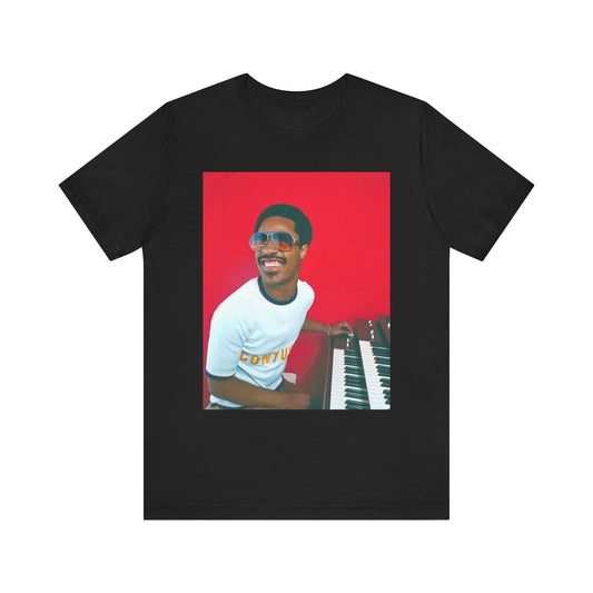 A black graphic t-shirt featuring a graphic of Stevie Wonder with a piano.