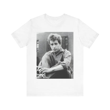 A black graphic t-shirt featuring a graphic of Bob Dylan from his 60s origins in folk music.