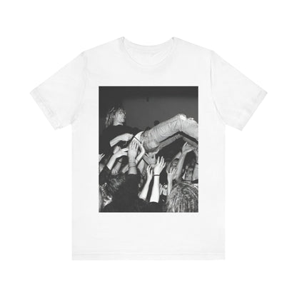 A black graphic t-shirt featuring a 90s graphic or photo of Kurt Cobain from Nirvana stage diving.
