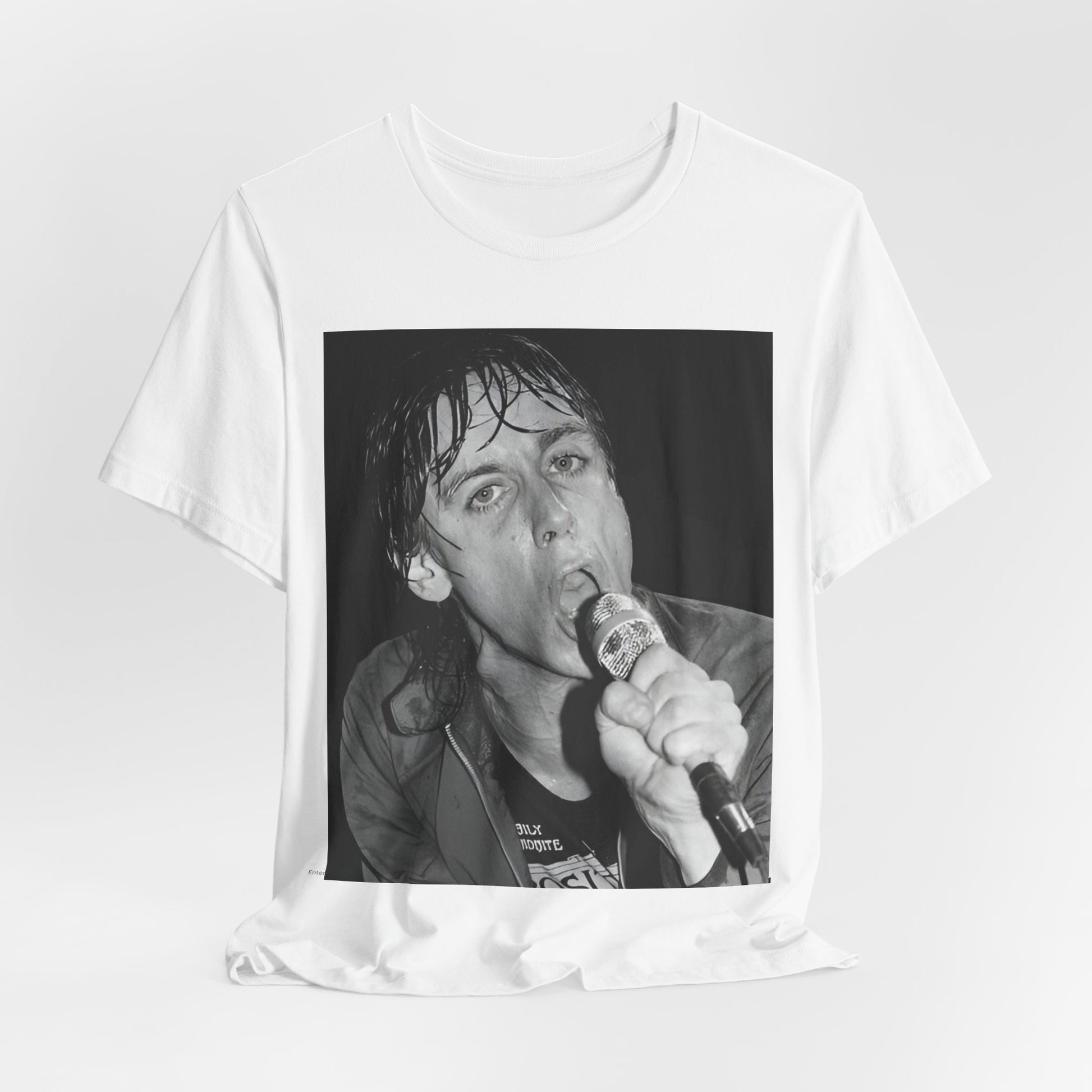 A black graphic t-shirt featuring a 70s graphic or photo of Iggy Pop performing in a wild concert.