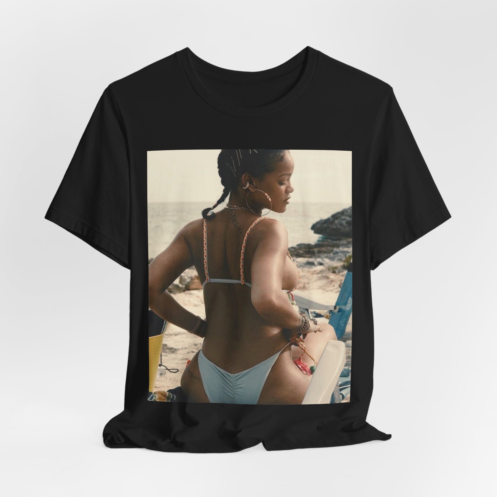 A black graphic t-shirt featuring a graphic of Rihanna as a bikini babe in paradise.