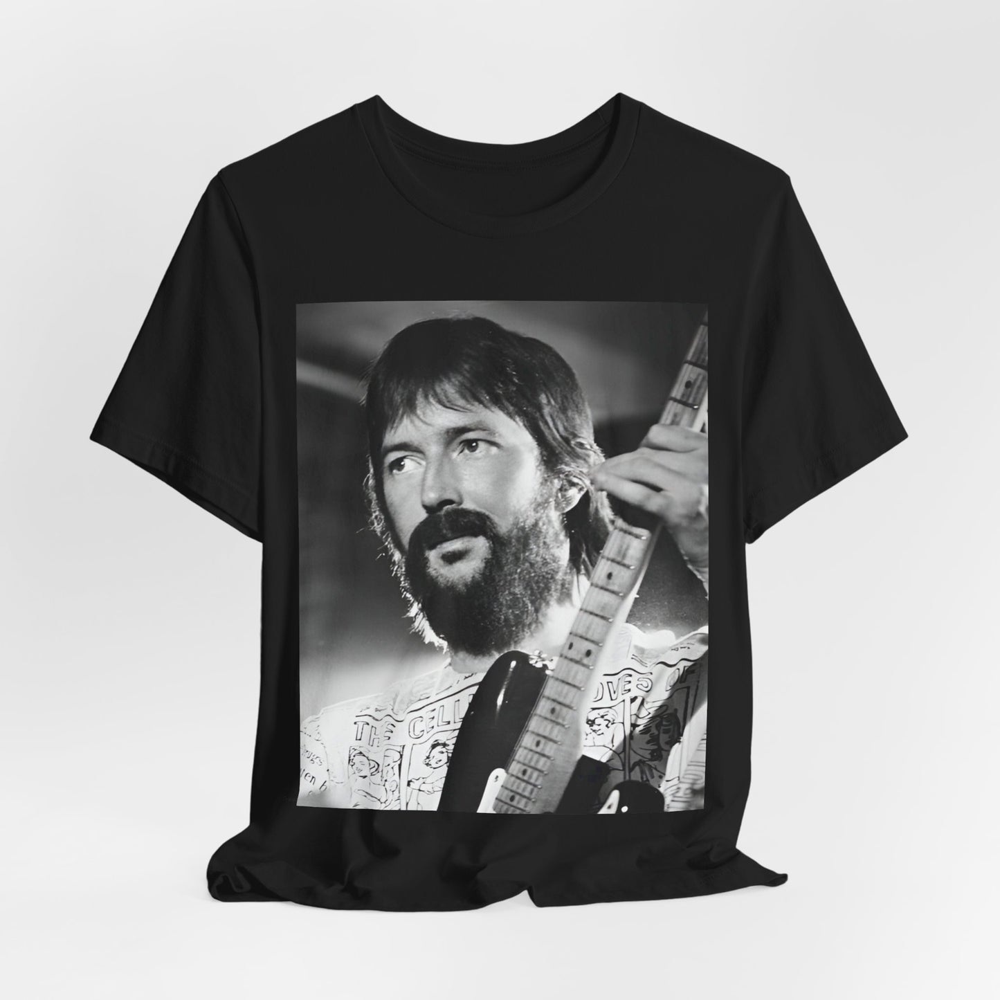 A black graphic t-shirt featuring a graphic of Eric Clapton as an authentic guitar god.
