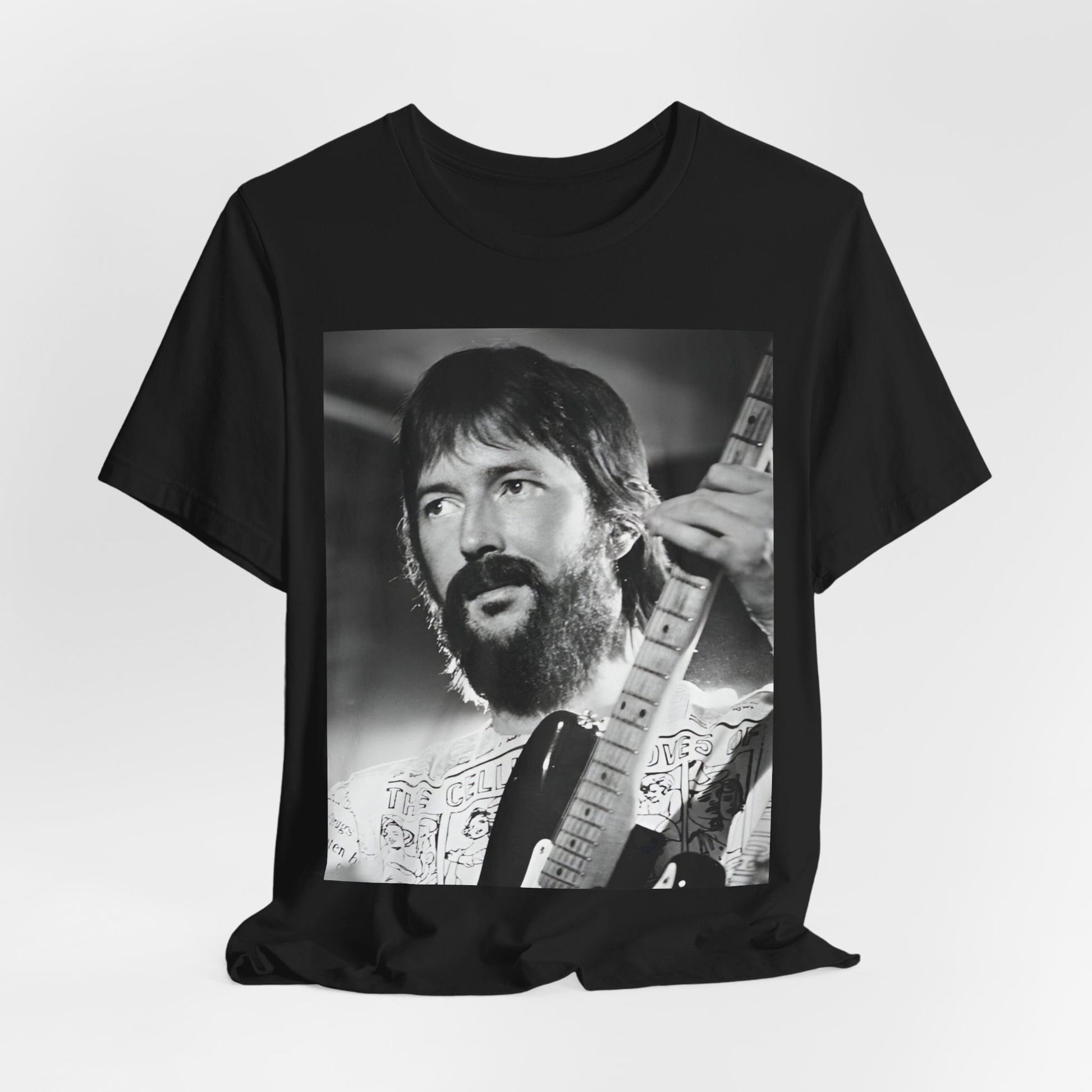 A black graphic t-shirt featuring a graphic of Eric Clapton as an authentic guitar god.
