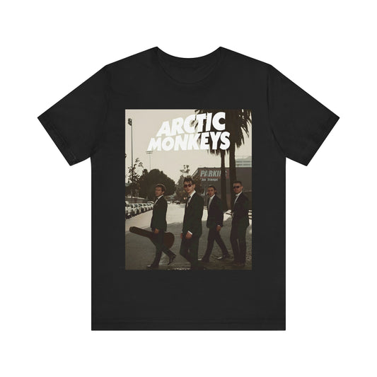 A black graphic t-shirt featuring Arctic Monkeys in a pose or setting similar to the iconic 'Abbey Road' album cover.