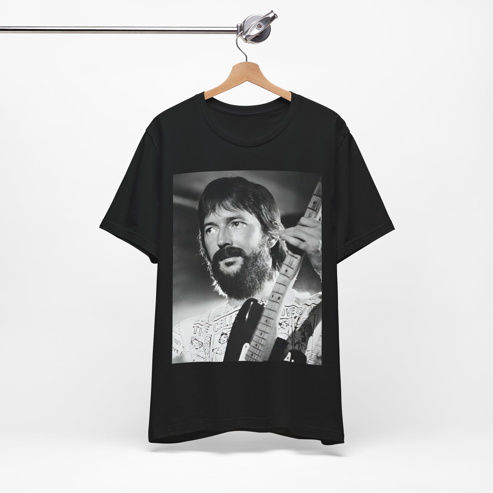A black graphic t-shirt featuring a graphic of Eric Clapton as an authentic guitar god.