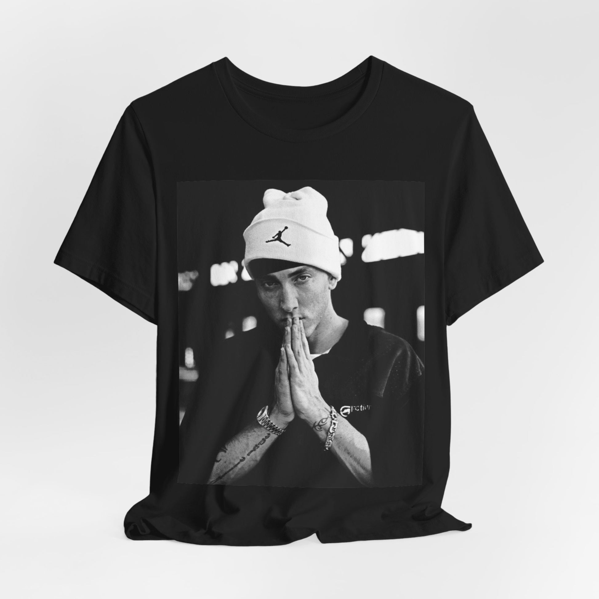A black graphic t-shirt featuring a black and white portrait photo of Eminem.