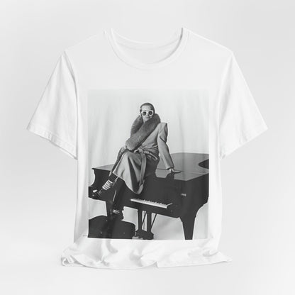 A black graphic t-shirt featuring a black and white photo of Elton John playing the piano.
