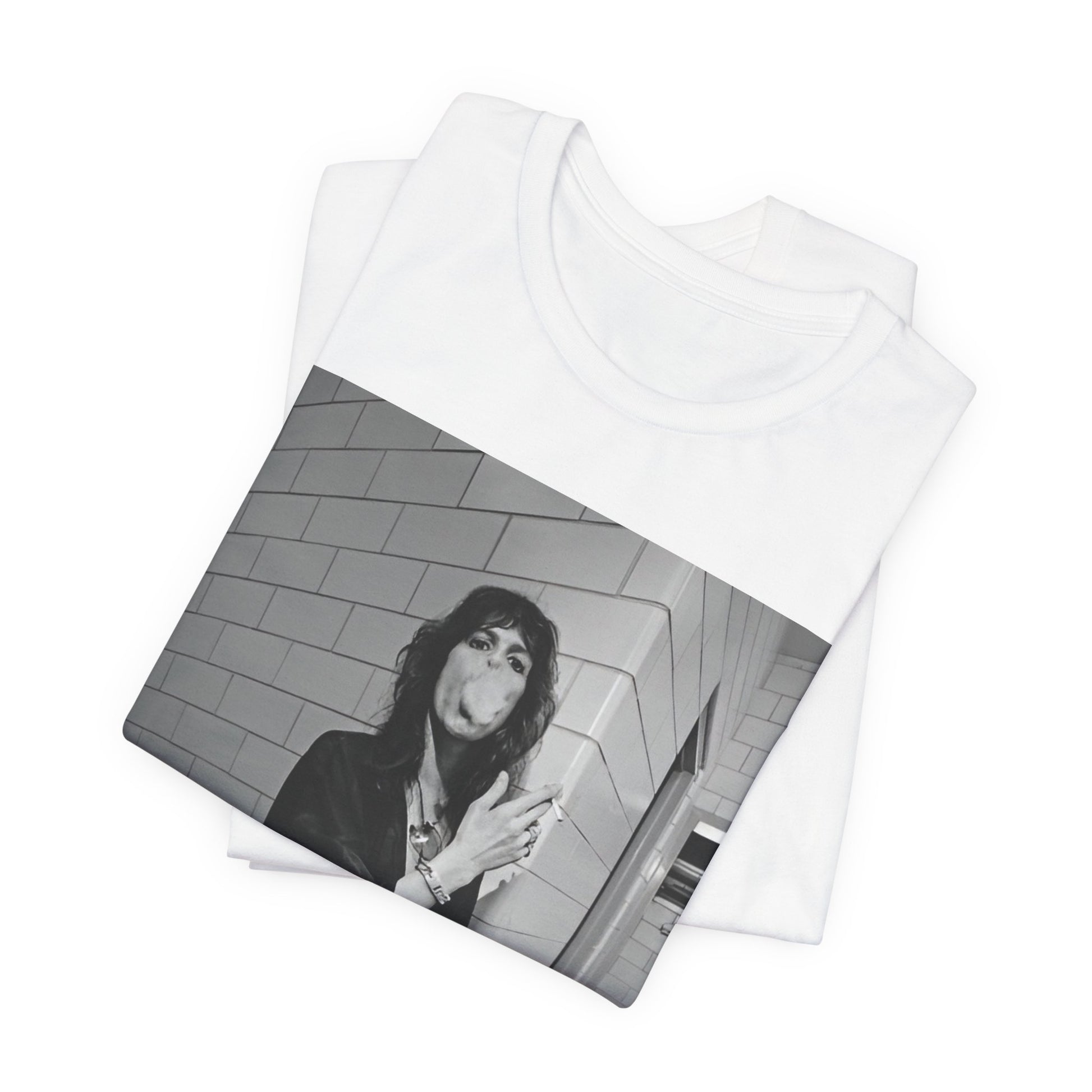 A black graphic t-shirt featuring a retro 70s photo of Aerosmith band members in a backstage setting, showing a candid moment.